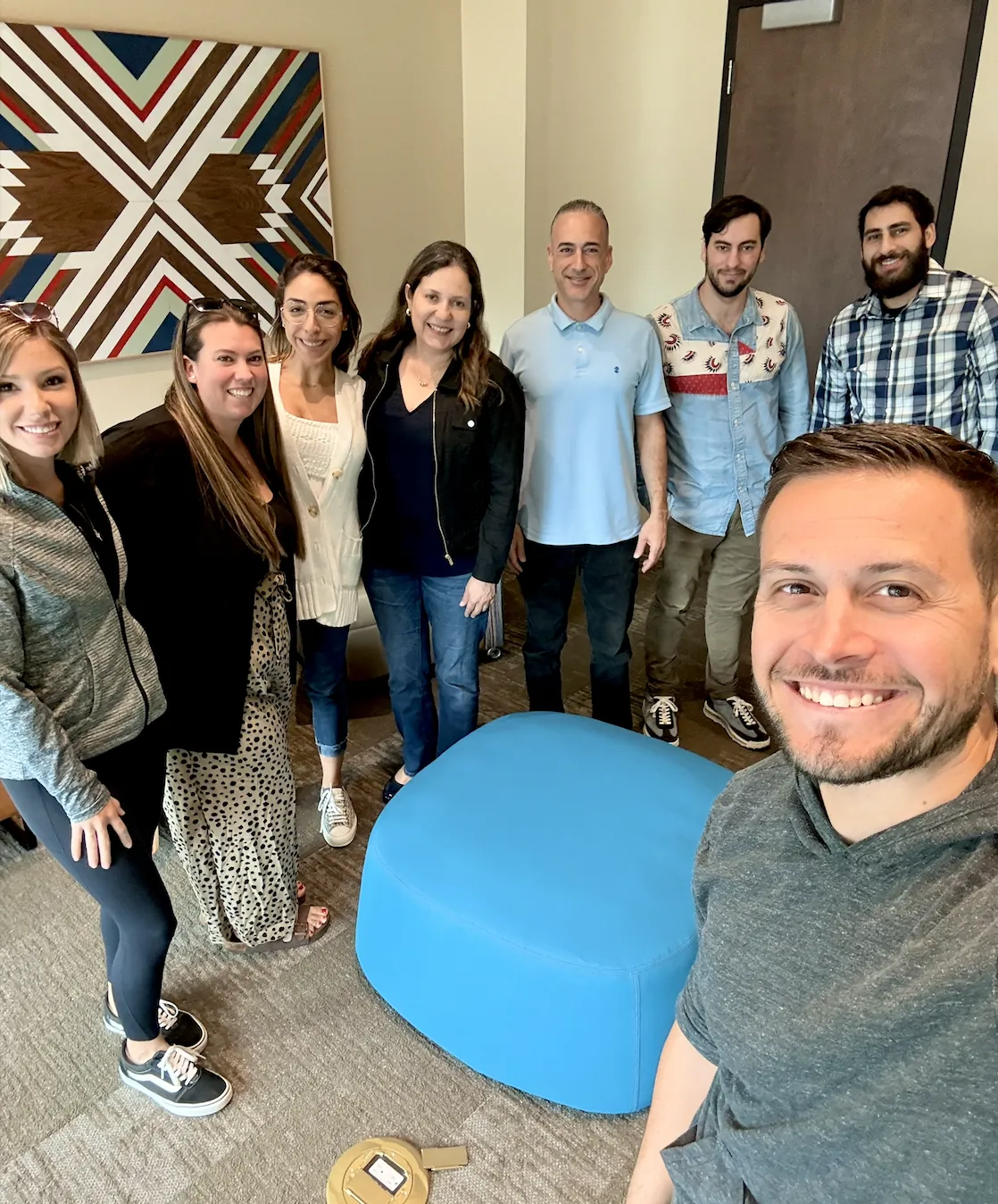 Chad Leonberg and his team taking a group selfie in the office